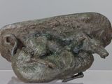 a sculpture of a ram on display in a glass case