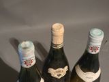 three bottles of wine that are sitting on a table