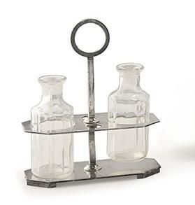 three glass bottles and a metal holder on a white surface