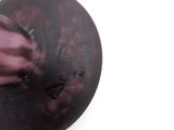 a black and purple object on a white surface