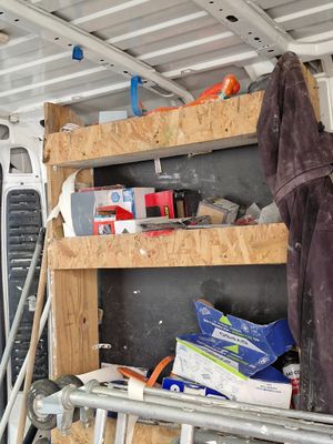 shelves in the back of a van filled with tools and supplies