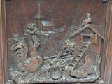 a wooden carving of a man and a woman on a boat
