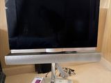 a flat screen tv sitting on top of a desk