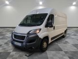 the white van is parked in a large room with checkered floor