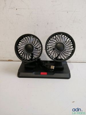 two small black fans sitting on top of a table