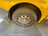 a close up of a tire on a yellow car