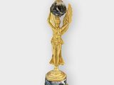 an image of a statue of a woman holding a globe on top of a table