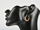a close up of a mannequin head wearing a pair of earrings