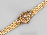 an 18k gold and diamond set wristwatch