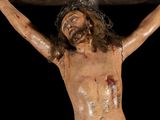 statue of jesus on the cross on a black background