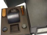 a black box with a watch and other items in it