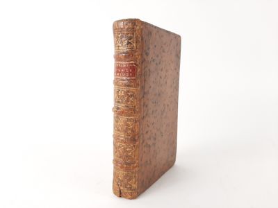 an old book sitting on top of a table next to a white background