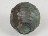 a close up of a small bronze object on a white surface