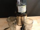 a blender that is sitting on a table next to two glasses