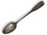 a spoon that is sitting on a white surface