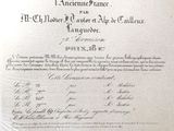 an old document with writing on it sitting on a table