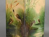 pair of decorative screen with birds and reeds painted on them