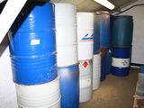 several blue and white barrels are stacked next to each other in a room