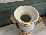 a vase that is sitting on a table next to a wall