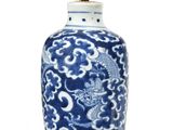 blue and white vase with a dragon design on it