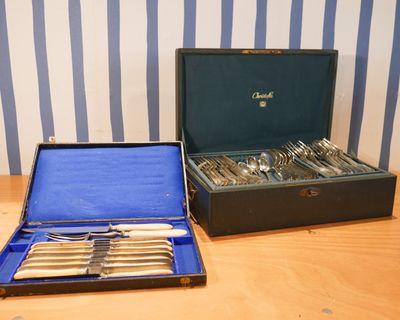 un coffret contenant de l'argenterie, posé sur une table en bois