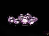 purple amethorate beads on a black surface