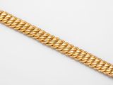 a gold chain bracelet on a white background