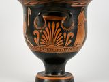 a black and orange vase sitting on a white surface