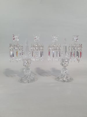 three crystal candlesticks sitting on a white table