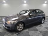 a picture of a grey bmw car in a showroom