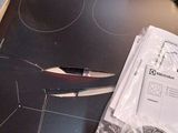 a pair of scissors sitting on top of a stove top