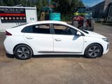 a picture of a white car parked in front of a building