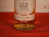 a bottle of liquor sitting on a red cloth
