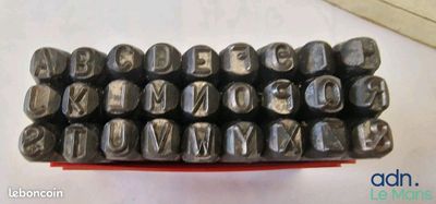 many metal typewriters sitting on a table