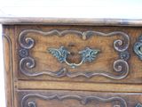 a wooden chest of drawers with ornate carvings on it