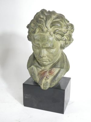 sculpture of a bust of a boy with curly hair on a black base