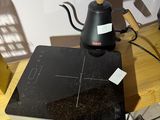 a black stove top with a tea pot on it