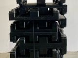 a stack of black plastic crates on top of a pallet
