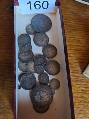 a box full of coins on a table with a price tag