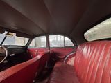 a red leather seat in the back of a car