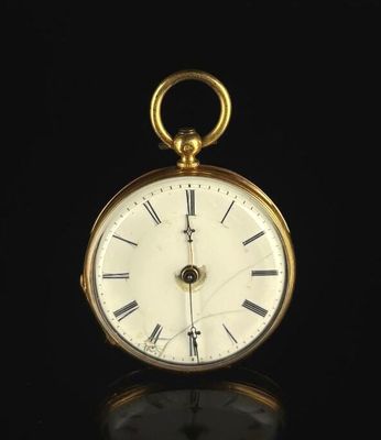a gold pocket watch with roman numerals on the face