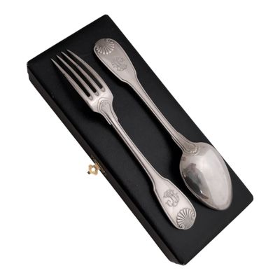 two forks and spoons in a black box on a white background