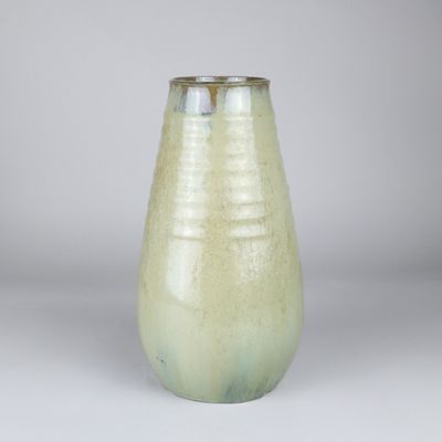a green vase that is sitting on a table
