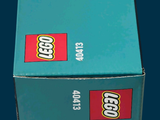 a box of legos sitting on a blue surface