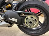a close up of a motorcycle with a chain attached to it