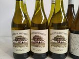 six bottles of wine are lined up on a table
