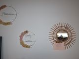 three mirrors hanging on the wall of a room