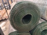 several rolls of green wire mesh are stacked on top of each other