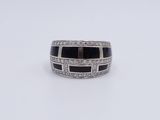 a white gold ring with black and white diamonds