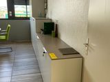 a small kitchen with a refrigerator and a table in it